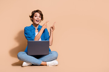 Poster - Photo of young freelance specialist woman pointing fingers empty space subscribe her social medias isolated on beige color background