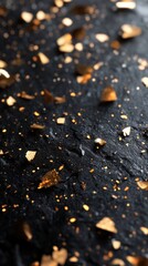 Wall Mural - Golden glitter reflecting light on a textured black surface