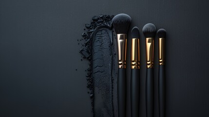 Wall Mural - A set of makeup brushes arranged on a textured black background with a paint-like smear.