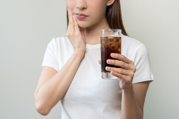 Health asian young woman touching her mouth, expression, suffering from toothache, decay or sensitivity cavity molar tooth or inflammation drink cold, sparkling water at home.Sensitive teeth people.