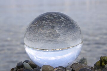 Poster - Crystal ball reflecting serene landscape and sky