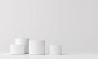 © Nanda - Minimalist product display with white cylinder podiums against a white backdrop. Perfect for showcasing beauty or lifestyle products.
