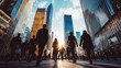 © somneuk - A group of business professionals walking through a city business district, with skyscrapers towering overhead
