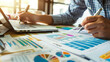 © Swaroop - A detailed image of a tax planning meeting between a small business owner and a tax advisor. The advisor is explaining tax-saving strategies for the business.