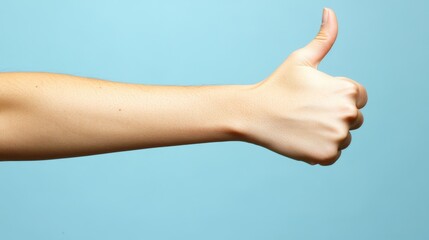 Wall Mural - Up close view of thumbs up gesture on blue background