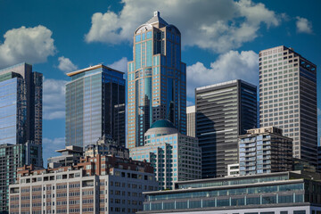 Wall Mural - 2024-08-15 SEATTLE SKYLINE WITH SEVERAL OFFICE TOWERS AND A SKY WITH WHITE PUFFY CLOUDS 