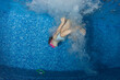 © frantisek hojdysz - A sporty little girl in a nice swimsuit swims underwater in the pool at the bottom. Underwater photography.