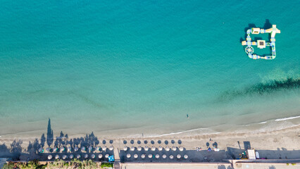 Poster - Aerial landscape view of tropical summer palm trees shadows on sandy coast ocean waves splash crash. Beautiful top view sunny sea coast, exotic amazing nature landscape. Abstract Mediterranean pattern