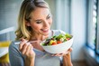 © Евгений Порохин - A woman is eating a salad with a spoon