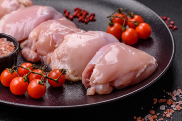 Wall Mural - Fresh chicken fillet on a dark concrete table with spices and herbs