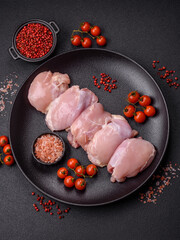 Wall Mural - Fresh chicken fillet on a dark concrete table with spices and herbs