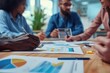 © useful pictures - Close up of diverse businesspeople brainstorm discussing paperwork share project ideas together, employees gather consider financial paper handout material, company statistics at office briefing