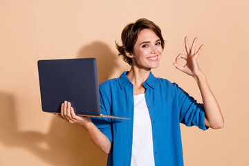 Poster - Photo of attractive lady in office working as professional system administrator engineer okey symbol isolated on beige color background