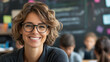 © Anzhela - Portrait of smiling woman teacher in glasses in class at elementary school looking at camera