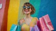 © Johannes - Portrait of satisfied laughing excited fashionable stylish woman wearing sunglasses with paper colorful shopping bags outdoors