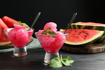 Poster - Tasty watermelon sorbet with mint in glass dessert bowls on black wooden table