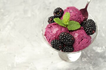 Canvas Print - Delicious blackberry sorbet, fresh berries and mint in glass dessert bowl served on gray textured table, closeup. Space for text