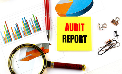 Poster - AUDIT REPORT text on yellow sticky on chart with magnifier and pen