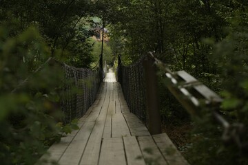 Canvas Print - View of long wooden suspension bridge outdoors