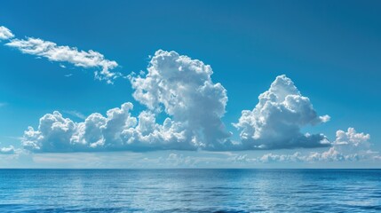Poster - A large ocean with clouds in the sky, suitable for use as a background or in travel and outdoor related projects