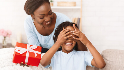 Wall Mural - African American Mom Making Birthday Gift For Daughter, Girl Waiting for Present