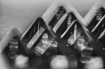 Close-up macro of sewing studs arranged in symmetrical rows in black and white abstraction abstract