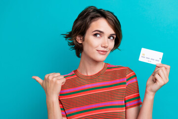 Canvas Print - Photo of cute woman dressed striped t-shirt holding debit card look directing at sale empty space isolated on turquoise color background