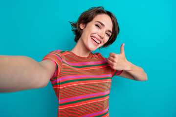 Canvas Print - Photo of cheerful glad lovely girl dressed stylish clothes sowing thumb up cool offer news feedback isolated on cyan color background