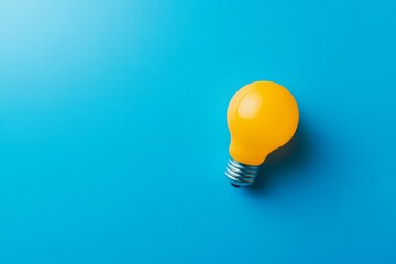 Poster - A vibrant yellow light bulb is positioned flat against a smooth, bright blue surface, creating an eye-catching contrast and minimalistic aesthetic