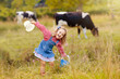 © famveldman - Kids watch cow on dairy farm