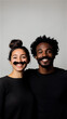 © Olga Davydova - Young black man with mustache with his girlfriend with false mustache posing and smiling. she supports him in movember. poster, leaflet.