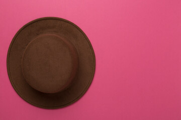 Brown autumn hat on color background, top view