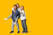 © Pixel-Shot - Happy family in stylish denim clothes having fun together on yellow background
