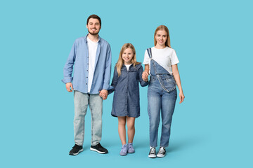 Wall Mural - Happy family in stylish denim clothes on blue background