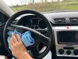 © Oksana - A man cleans the car interior and dashboard with a microfiber cloth. car interior cleaning