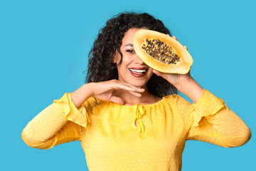 Sticker - Beautiful African-American woman with fresh papaya on blue background