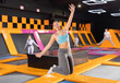 © JackF - Cheerful young European female in sportswear bouncing and jumping on trampolines indoors in leisure sports center