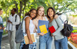© Prostock-studio - Cheerful multinational girlfriends with books and notebooks posing in park after studying