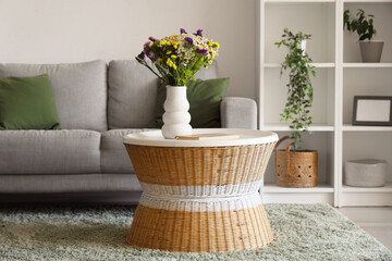 Poster - Cozy sofa and vase with wild flowers on coffee table in living room