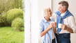 © Prostock-studio - Happy senior couple talking near window and drinking tea, copy space