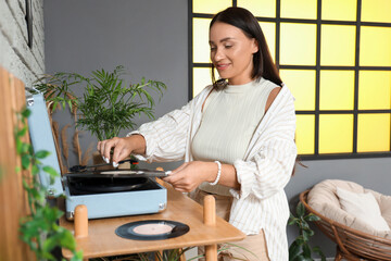 Sticker - Young woman using record player at home