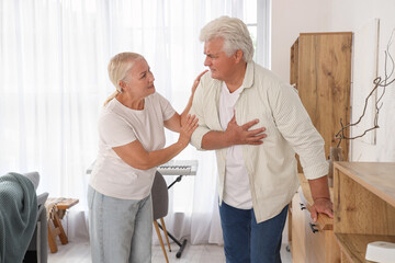 Canvas Print - Mature man having heart attack with his wife at home