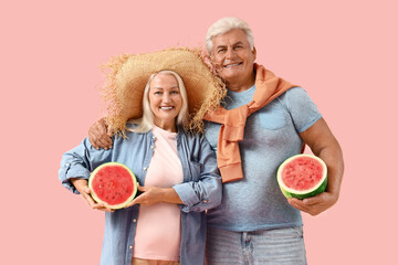 Poster - Mature couple with halves of watermelon on pink background