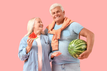 Poster - Mature couple with watermelon on pink background