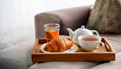 Wall Mural - breakfast tray with tea and croissant on couch