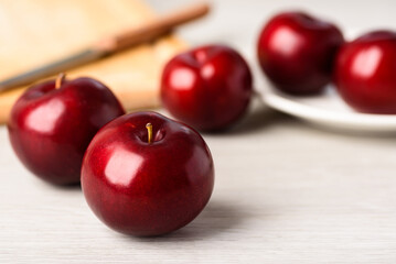 Fresh red plum on white background