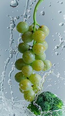 Wall Mural - Fresh grapes and broccoli in a glass of water with droplets, healthy food and nutrition concept