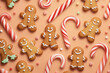 © KC - a gingerbread man is standing in front of a candy cane
