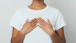 © Pro Hi-Res - Individual with hands crossed over chest, wearing a plain white t-shirt, poses against a neutral background.