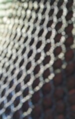 a highly blurred abstract pattern of luminous hexagons and dark spaces creates a soft, dreamy bokeh 